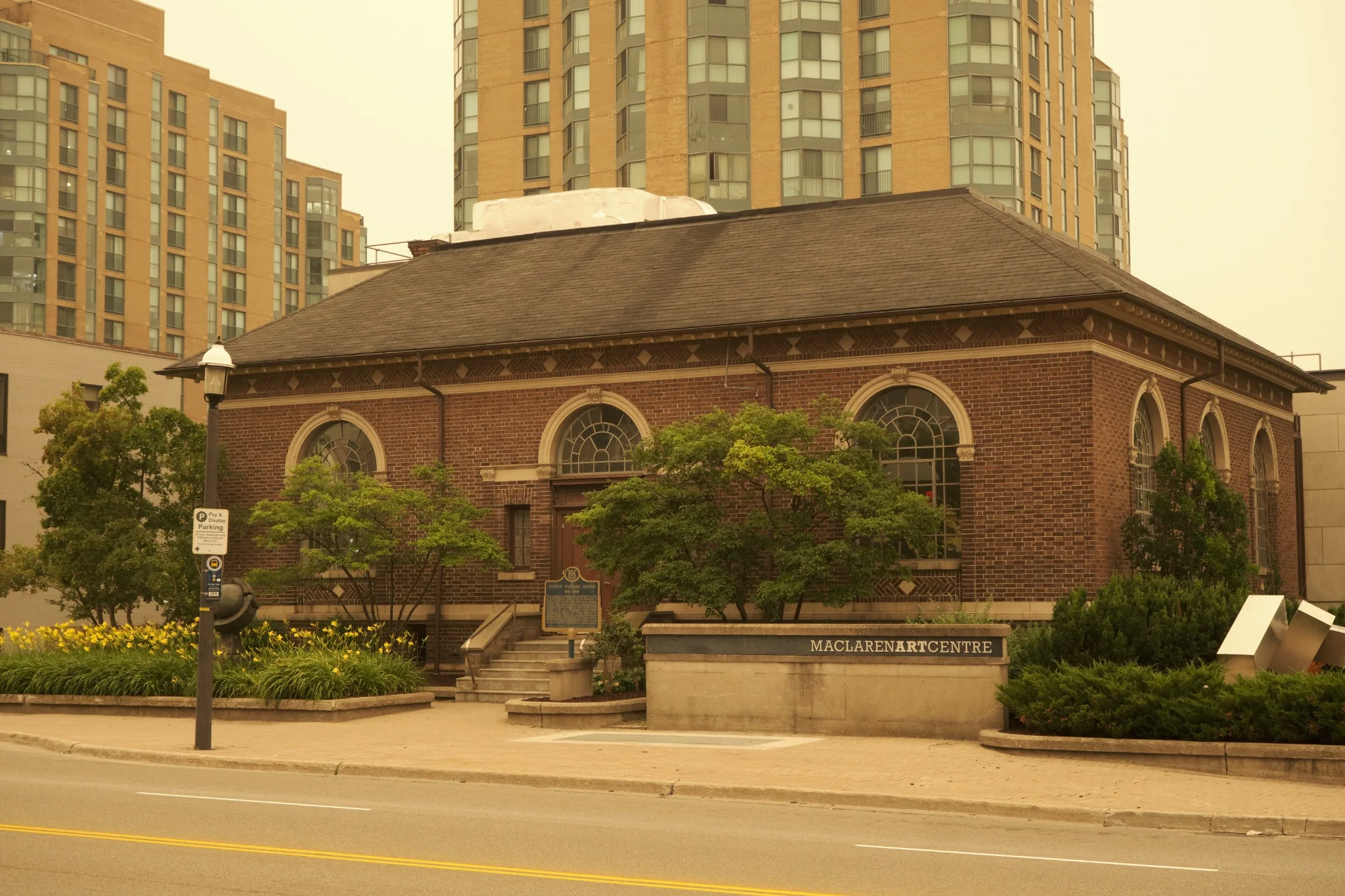 Historic brick art centre framed by contemporary residential towers